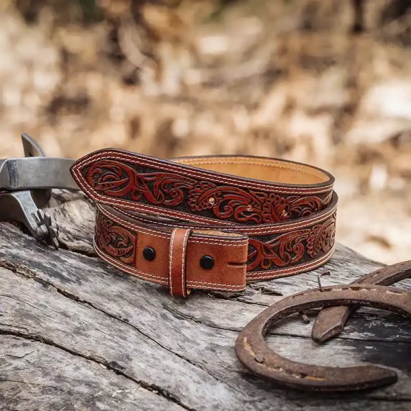A brown full grain leather belt for men  featuring tooled vines 